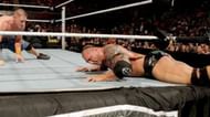 Batista's legs taped to the ring-post